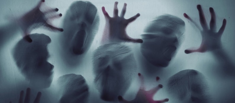 May include: A blurry image of multiple ghostly figures and hands reaching out from behind a frosted glass surface. The figures are translucent and appear to be in a state of distress.