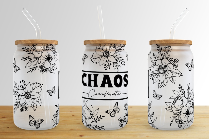 May include: Three white reusable tumblers with black floral designs and black straws. The middle tumbler has the text "CHAOS -Coordinator- ".