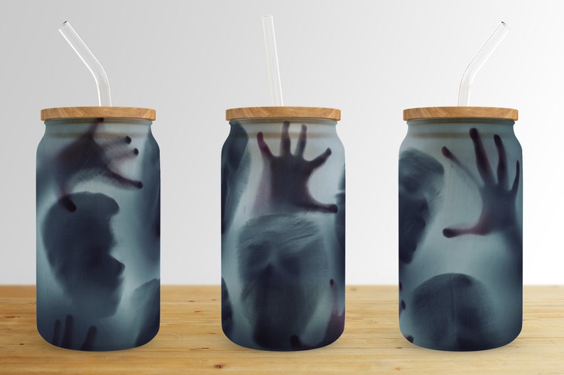 May include: Three glass tumblers with wooden lids and clear straws. Each tumbler features a ghostly image of a hand and face.