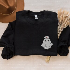 Embroidered nurse doctor ghost halloween sweatshirt in the colour black