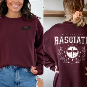 Four wing embroidered front with basgiath war college vintage print on the back of maroon sweatshirt