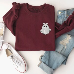 Embroidered nurse doctor ghost halloween sweatshirt in the colour maroon