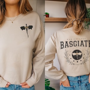 Four wing embroidered front with basgiath war college vintage print on the back of sand sweatshirt