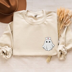 Embroidered nurse doctor ghost halloween sweatshirt in the colour sand