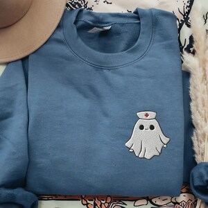 Embroidered nurse doctor ghost halloween sweatshirt in the colour indigo blue