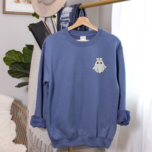 Embroidered nurse doctor ghost halloween sweatshirt in the colour indigo blue on hanger