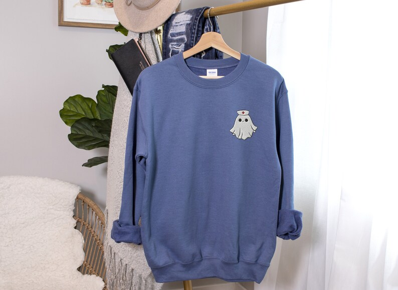 Embroidered nurse doctor ghost halloween sweatshirt in the colour indigo blue on hanger