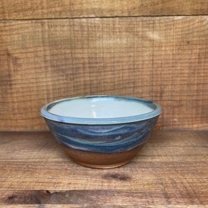 Mini ceramic bowl with green marble swirl design.