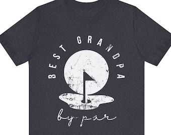 May include: A dark heather grey t-shirt with a white distressed graphic of a golf ball and flag with the text "BEST GRANDPA by par".