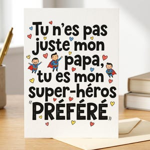 以下が含まれることがあります： フランス語のテキスト「Tu n'es pas juste mon papa, tu es mon super-héros PRÉFÉRÉ」が黒で書かれた白いグリーティングカード。カードには、漫画のスーパーヒーローと赤、青、黄色の小さなハートのイラストが描かれています。