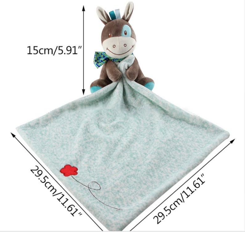 May include: A soft, blue and white baby blanket with a brown and blue plush donkey attached. The blanket measures 29.5cm by 29.5cm and the donkey is 15cm tall.