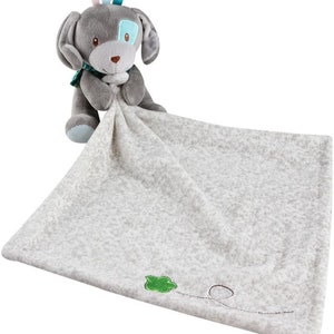 May include: A grey and white plush security blanket with a grey puppy attached. The puppy has blue eyes and a blue and green bow tie. The blanket has a green embroidered leaf and a black embroidered line.