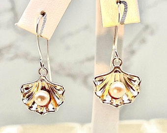 Sleek Silvery Seashell Drop Earrings accented with charming faux pearls.