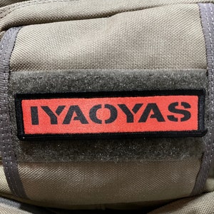May include: A gray fabric bag with a black velcro patch that says "IYACOYAS" in red letters.