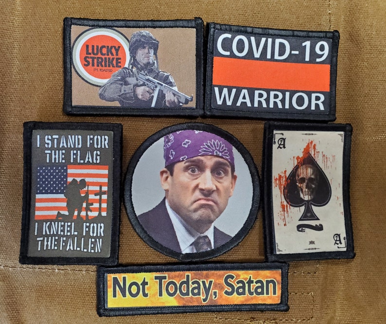 May include: A collection of seven embroidered patches. The patches feature various designs, including a military soldier, a skull, a flag, and the text "COVID-19 Warrior".
