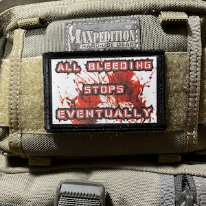May include: A black and white patch with red splatter. The patch reads "All Bleeding Stops Eventually".