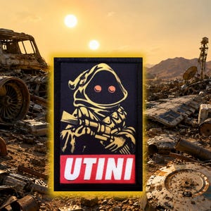May include: A rectangular embroidered patch featuring a hooded figure with glowing red eyes holding a blaster. The design is rendered in black, yellow, and white thread. Below the figure, a red rectangular banner displays the white text UTINI.