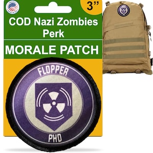 May include: A 3-inch round morale patch featuring the Call of Duty Zombies perk "Flopper". The patch is purple with a white background and features a stylized radiation symbol. The text "Flopper" is at the top of the patch and "PhD" is at the bottom.