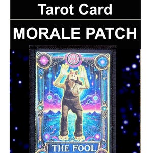 May include: A 2x3 inch (approx. 5 x 7.6 cm) morale patch with a tarot card design. The patch reads "Jar Jar The Fool Tarot Card" and "MORALE PATCH". The card illustration shows a figure with raised arms, against a colourful, cosmic backdrop. Made in the USA.