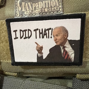 May include: A white patch with black text that reads "I DID THAT!" and a picture of a man in a suit and red tie pointing to the right.