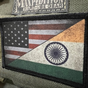 May include: A black and green patch with the American flag and the Indian flag sewn together. The patch has the text "Maxpedition Hard-Use Gear" on it.