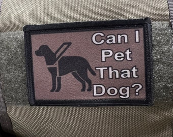 May include: A brown patch with black stitching features a black silhouette of a dog wearing a harness and the text "Can I Pet That Dog?"