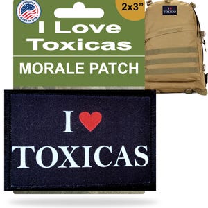 May include: A black morale patch with the text "I Love Toxicas" and a red heart. The patch is 2x3 inches and is displayed with a tan backpack. The packaging reads "Proudly Made in USA."