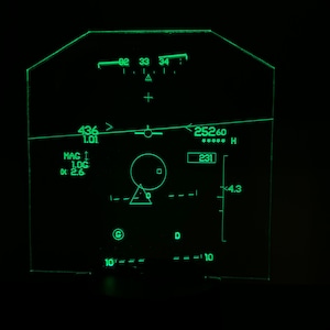 May include: A green digital display with a compass, altitude, and heading readings. The display shows a heading of 25260, an altitude of 231, and a compass reading of 436. The display also shows a small triangle with a circle inside, and the letters G and D.