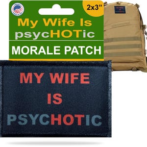 May include: A black morale patch with the text "MY WIFE IS PSYCHOTIC" in red and blue letters. The patch is 2x3 inches. A tan backpack is in the background, with a smaller patch that says "MY WIFE IS PSYCHOTIC".