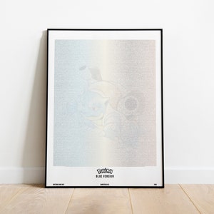 May include: A framed poster with a pixelated image of the Pokemon characters Bulbasaur, Charmander, and Squirtle. The poster has a blue, white, and yellow gradient background. The text "Pokemon Blue Version" is at the bottom of the poster.