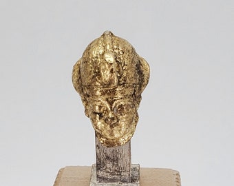 Miniature Gilded bust of King Tut, similar to items found in his tomb.