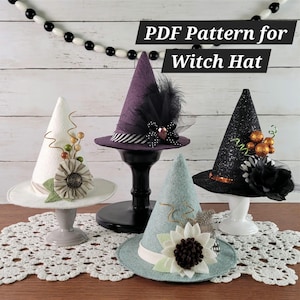 May include: Four miniature witch hats in white, purple, light blue, and black, each decorated with fabric flowers, feathers, or glitter. The text PDF Pattern for Witch Hat is displayed above the hats, which are resting on small stands.
