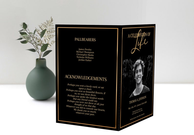 Front and back of a funeral program standing up. A large photo is on the front of the program with gold text, gold text is also on the back of the pamphlet. Black background, with gold border.
