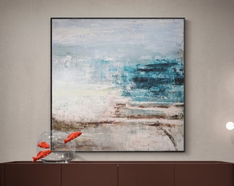 May include: An abstract painting with shades of blue, white, and brown hangs above a brown cabinet. A glass bowl with three red fish sits on the cabinet. The cabinet has a minimalist design with black legs.