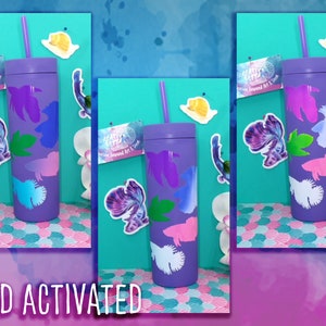 May include: A purple tumbler with a straw, displaying fish-shaped designs that change colour when cold. The tumbler has a matching lid and straw. The words "COLD ACTIVATED" are at the bottom of the image.