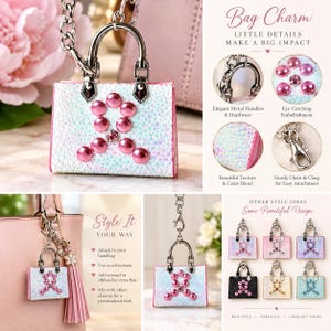 May include: A miniature handbag bag charm featuring a white iridescent textured surface with a pink rhinestone ribbon emblem. It includes silver-tone metal handles, a sturdy chain, and a lobster clasp for attachment to larger bags or keys.