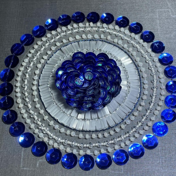 Circular applique of blue sequins and white seed beads; circle applique, motif with seed beads and bugle beads.