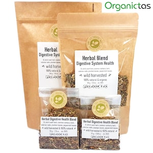 May include: Three brown paper bags with white labels containing a blend of dried herbs for digestive health. The labels read "Herbal Digestive System Health" and list the ingredients: St. John's wort herb, common centaury herb, valerian roots, plantain leaves, and peppermint leaves. The bags are labelled with "wild harvested" and "100% natural & organic".