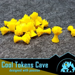 May include: A group of 18 bright yellow plastic wheat stalks, each with a small, round base. The stalks are arranged in a pile on a gray textured surface.