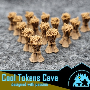 Puede incluir: Un conjunto de pequeños haces de trigo, atados con cuerda, dispuestos sobre una superficie gris texturizada. El trigo es de color marrón claro, y la cuerda es de un tono ligeramente más oscuro. Incluye el texto "Cool Tokens Cave" y "designed with passion".