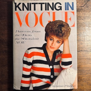 May include: A vintage book cover for "Knitting in Vogue" with a woman in a striped orange, black, and white cardigan. The cover text promotes knitting patterns from the 1930s to the 1980s. The author's name is Christina Probert.