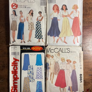 May include: Four sewing patterns for skirts. The patterns are from McCall's and Simplicity. The patterns feature different styles of skirts, including a-line, full, and gathered skirts. The patterns are for sizes 8-18.