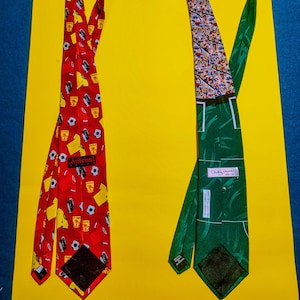May include: Two neckties on a yellow background. One is red with yellow soccer jerseys, soccer balls, and the word "Arsenal". The other is green with a patterned top and the name "Vicky Davies".
