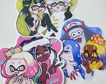 May include: Five colorful cartoon stickers featuring characters from the video game Splatoon. The stickers are on a white background. The characters are wearing different outfits and accessories.