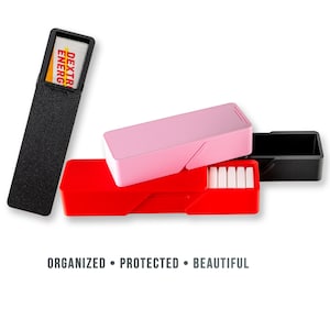 May include: An assortment of colorful, rectangular storage cases. One black case holds a battery with the text "DEXTER ENERGY". A red case and a pink case are also shown, along with the text "ORGANIZED • PROTECTED • BEAUTIFUL".