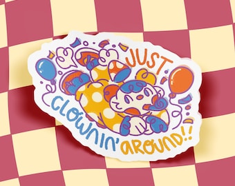 May include: A die-cut sticker featuring a cartoon clown character in a yellow polka-dot outfit with blue accents, surrounded by balloons and confetti. The text "JUST CLOWNIN' AROUND!!" is written in a playful, hand-drawn orange and blue font.