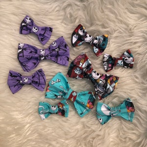 May include: A collection of handmade fabric bow ties featuring designs from the movie "The Nightmare Before Christmas." The bows showcase characters like Jack Skellington and Sally, in various colors including purple, teal, and black.