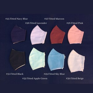 May include: A collection of eight fitted face masks in various colors, including navy blue, lavender, maroon, pink, black, sky blue, apple green, and beige. Each mask is labeled with a number and color name against a dark blue background.
