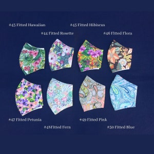 May include: A collection of eight fitted face masks with various floral and paisley patterns. Each mask is labeled with a number and a descriptive name, such as "Fitted Hawaiian" and "Fitted Blue." The masks feature vibrant colors and designs, set against a dark blue background.