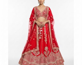 May include: A vibrant red lehenga, a traditional Indian garment, featuring intricate gold embroidery. The ensemble includes a matching choli and dupatta. The skirt has detailed floral and geometric patterns. The outfit is suitable for festive occasions.